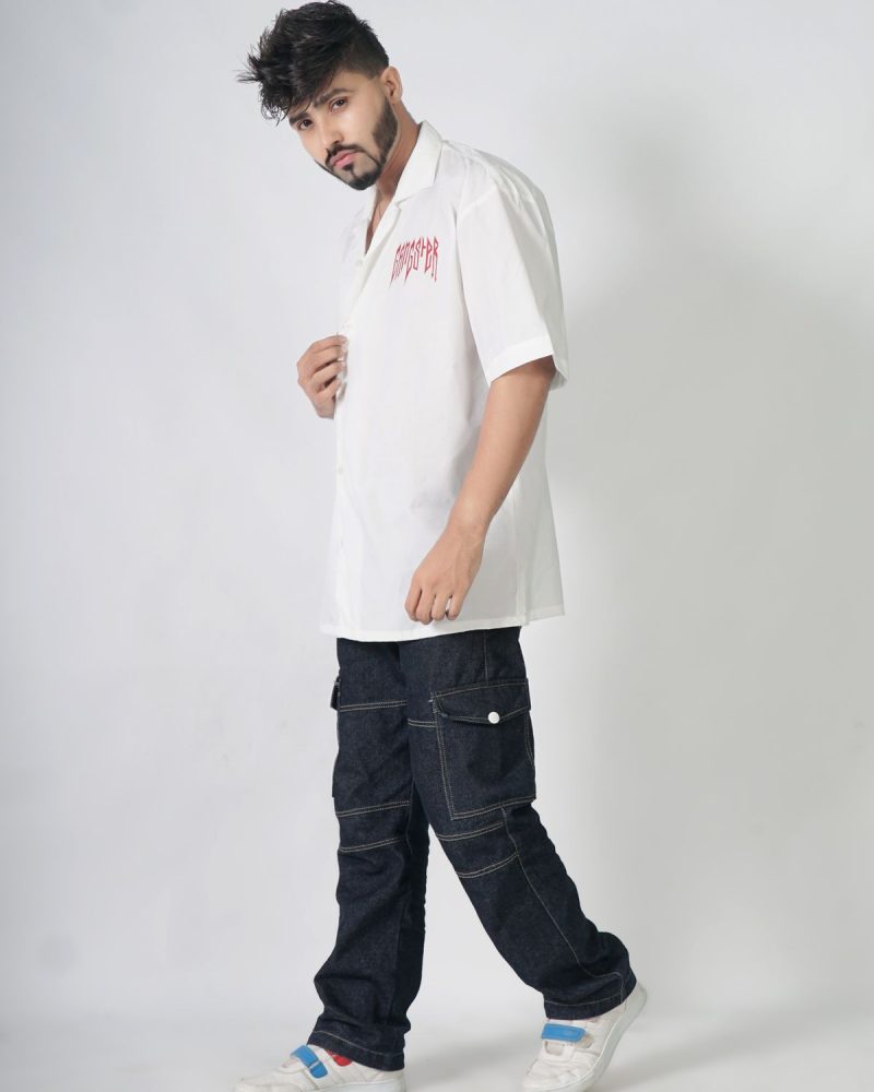 Man walking in black cargo pants and white shirt, studio shot